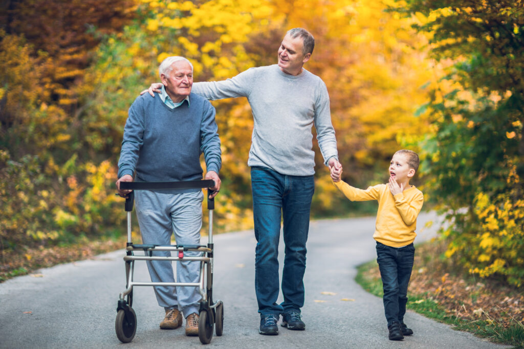 Older veteran being assisted by younger son.